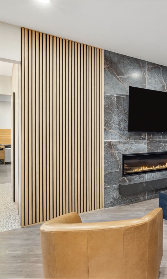 a living room with a couch and a chair and a fireplace
