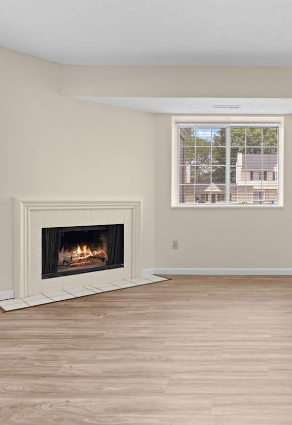A room with a fireplace and sliding glass doors.
