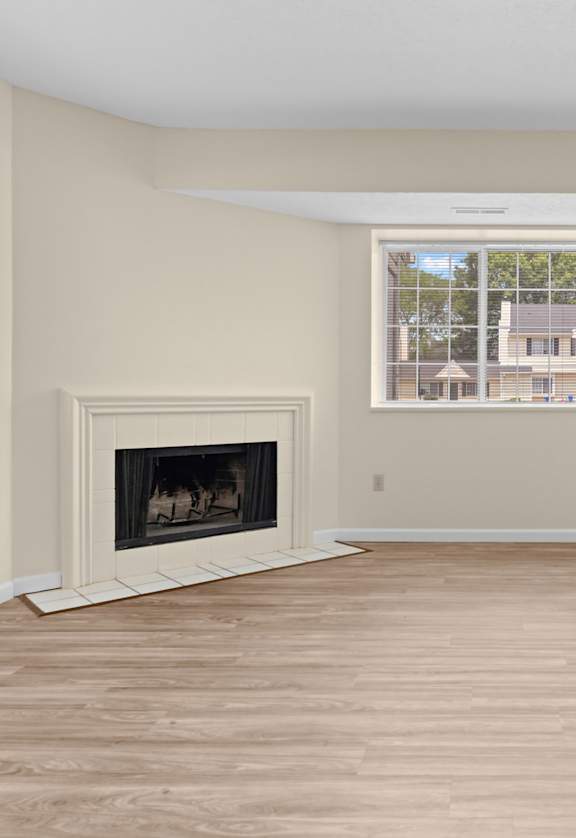A room with a fireplace and sliding glass doors.