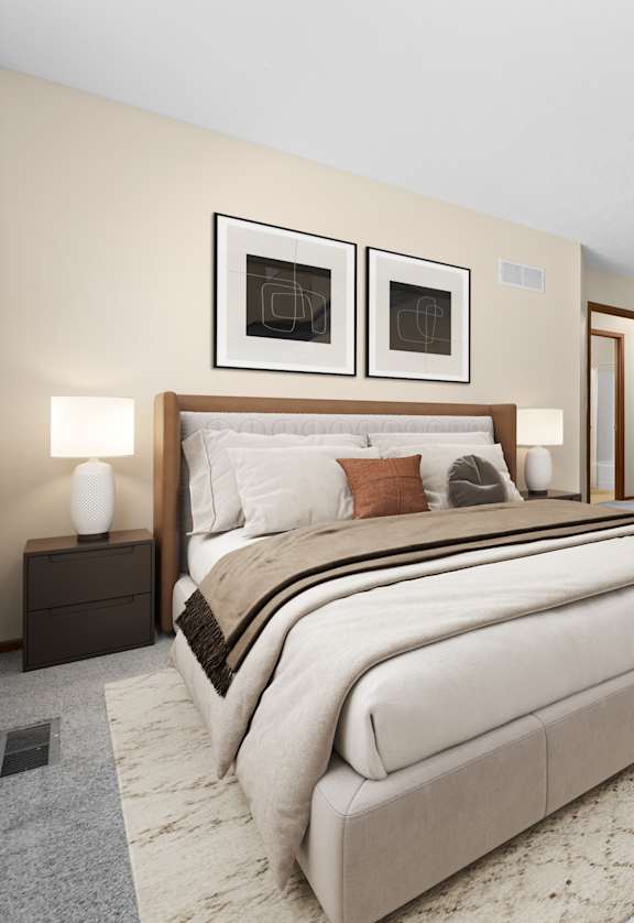 A bedroom with a large bed and a TV on the wall.