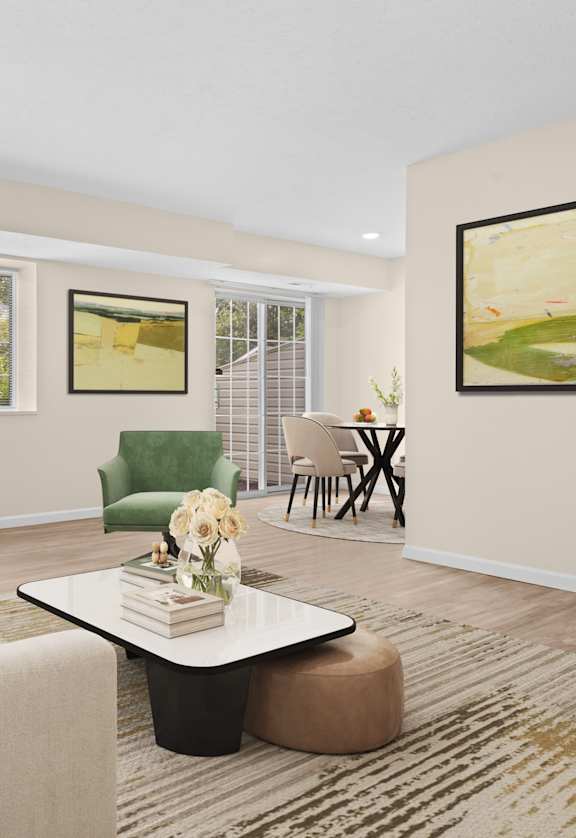 A living room with a green couch and a painting on the wall.
