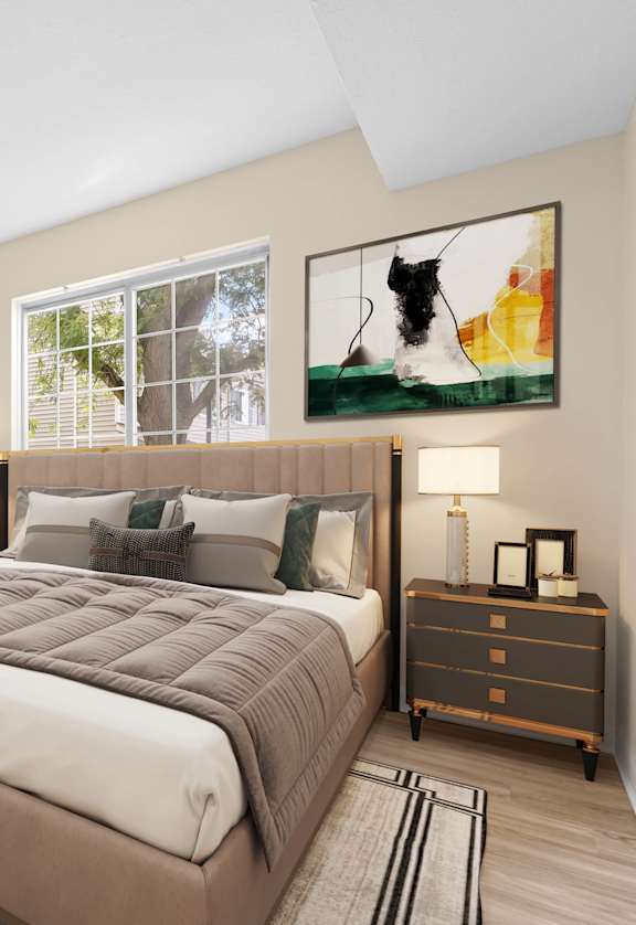 A bedroom with a large bed, two nightstands, and a plant.