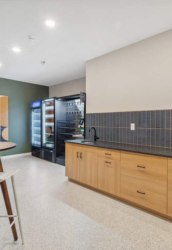 a kitchen with a table and chairs and a refrigerator