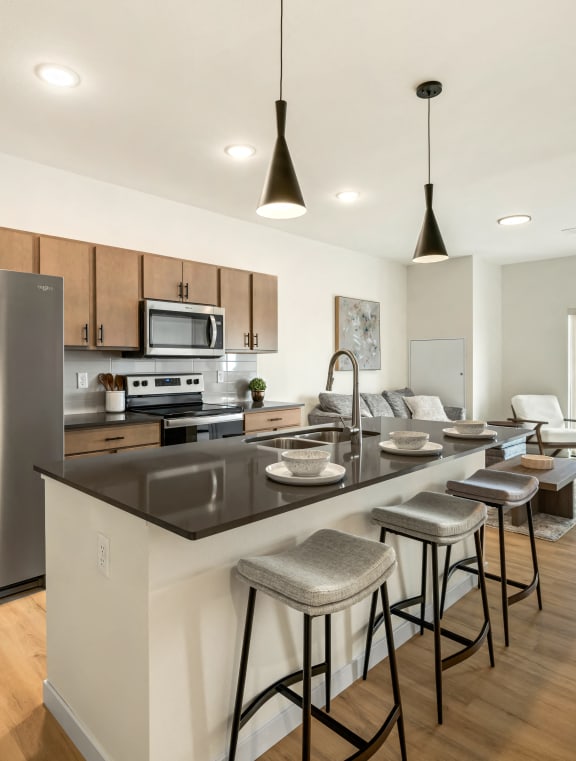 a kitchen with a large island and a stainless steel refrigerator at The Standard on 32nd, North Dakota, 58078