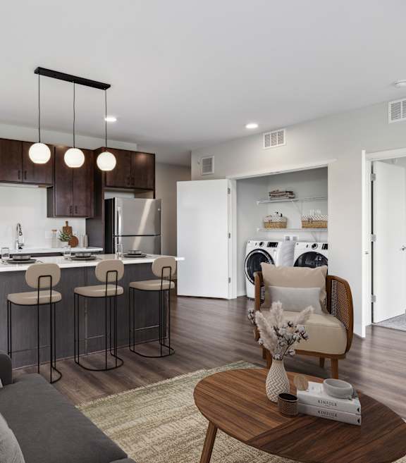 an open kitchen and laundry room with a washer and dryer