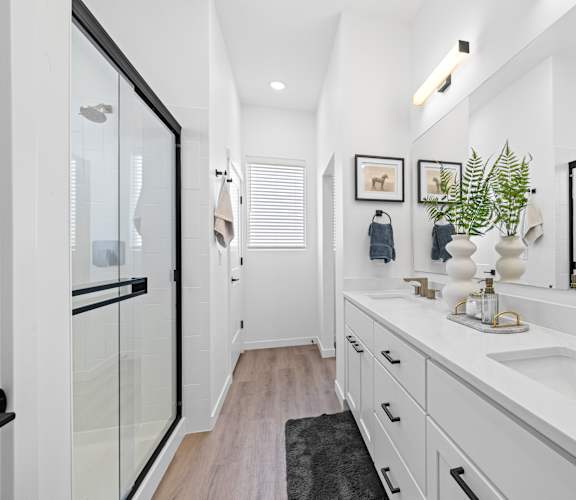 A bathroom with a white sink and a mirror.