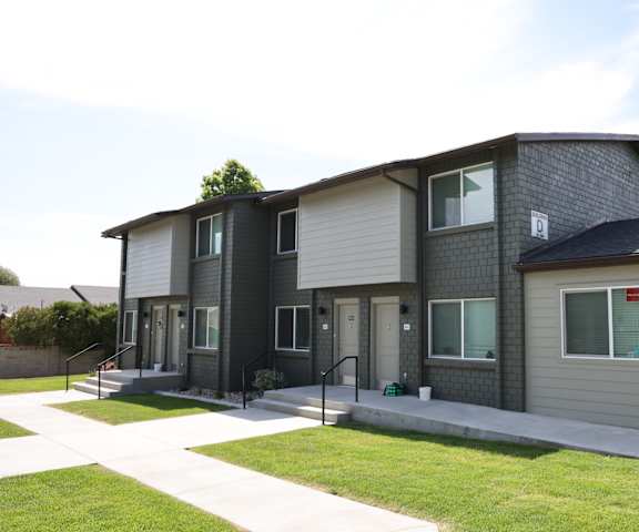 A modern two-story house with a grey and white exterior.