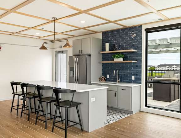 a kitchen with a white counter top and black bar stools at The Standard on 32nd, West Fargo, North Dakota