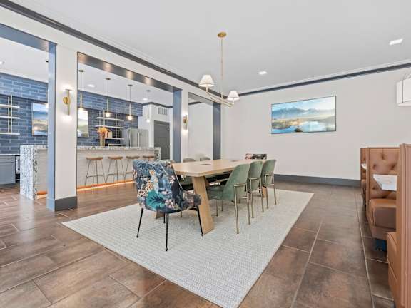 an outdoor lounge area of an apartment building with tables and chairs at Aster Apartments, Ohio