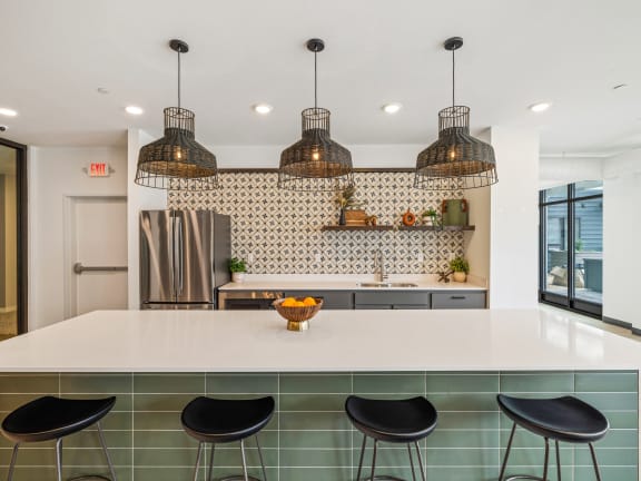 a kitchen with a white counter top and black stools at EagleRidge Plaza Residences, North Dakota, 58104