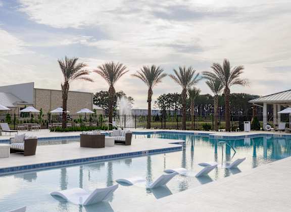 A large swimming pool with a white sculpture in the middle.
