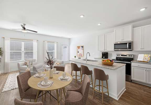 A kitchen with a table and chairs in the middle of the room.