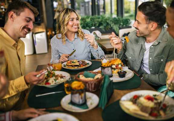 A group of people enjoying a meal together at a restaurant.