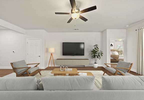 A living room with a grey couch and a wooden coffee table.