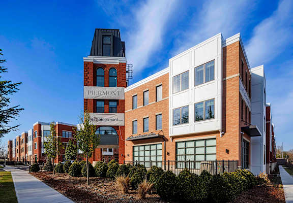 A modern building complex with a sign that reads "Permont" is shown.