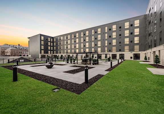 A modern building with a courtyard in front.