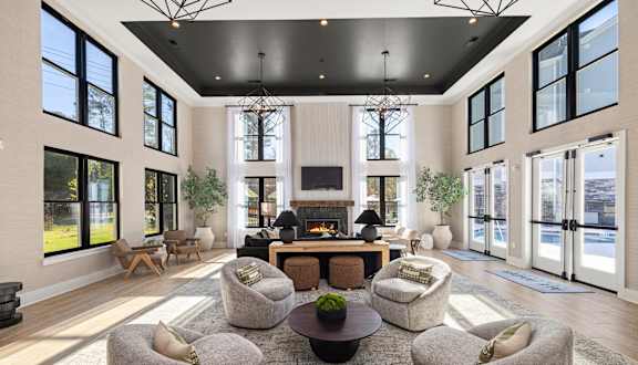 A living room with a fireplace and a large window.
