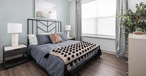 a bedroom with a bed and a large window