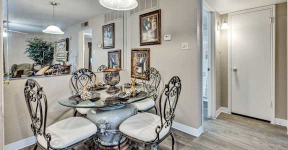the dining room of a home with a table and chairs