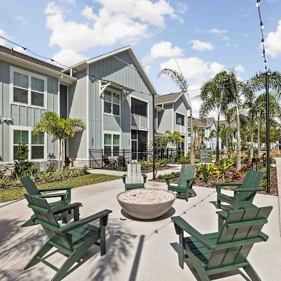 Outdoor space with chairs and a fire pit at Rockledge Apartments, Florida