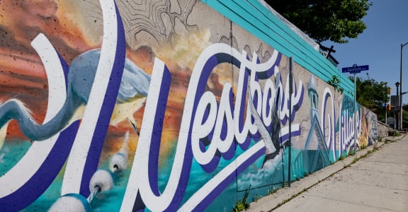A mural on the side of a building saying Westboro Village.