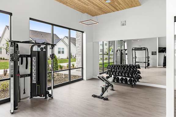 A gym with a row of dumbbells at Alante Homes at Spring Run, Caldwell