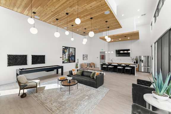 A modern living room with a wooden ceiling and a variety of furniture at Alante Homes at Spring Run, Caldwell, ID, 83607
