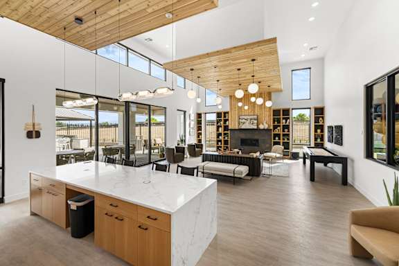 A modern kitchen with a large island and wooden ceiling at Alante Homes at Spring Run, Caldwell, Idaho