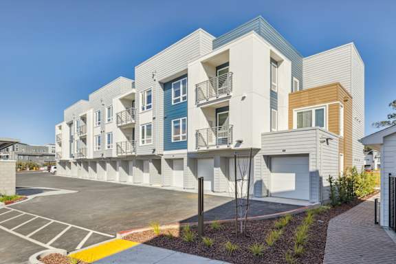 a row of modern apartments with balconies and a parking lot at 38° NORTH, Santa Rosa, 95404