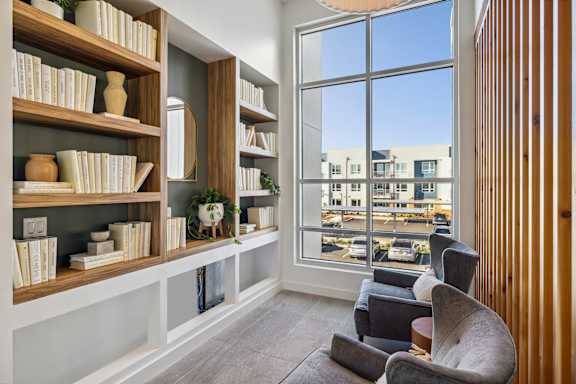 a living room with bookshelves and a large window at 38° NORTH, Santa Rosa, 95404
