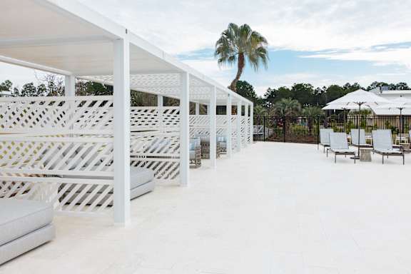 a rendering of the facade of a building with palm trees at Saltaire Apartment Homes, Florida