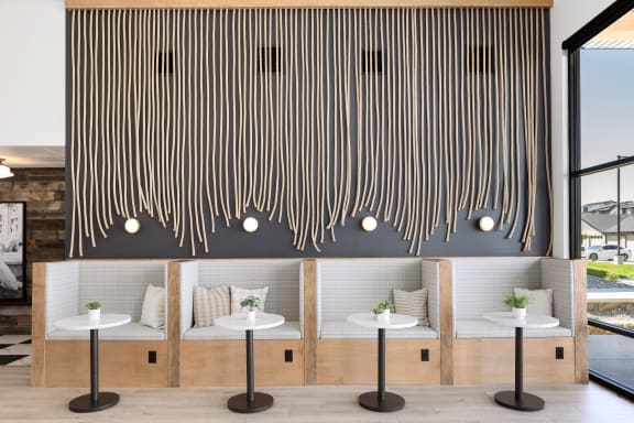 A wall with a striped design and three white tables in front of it. at The Expo, Billings, Montana