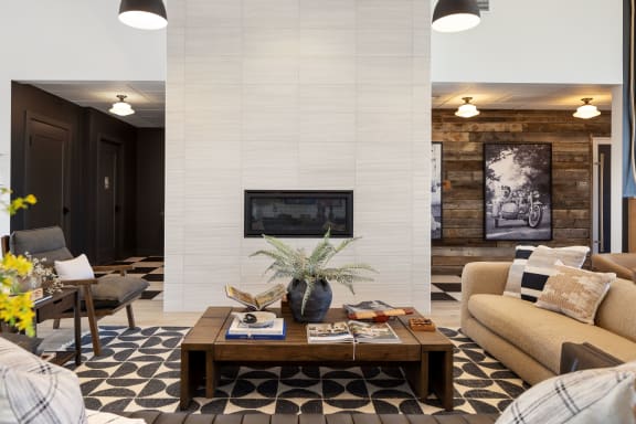 A living room with a fireplace and a coffee table. at The Expo, Billings, MT, 59106