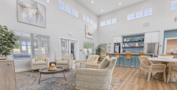a living room with couches and chairs and a kitchen with a table