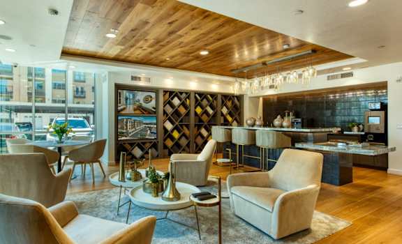 A modern living room with a wooden ceiling and a large window at Elevation San Tan, Gilbert, AZ, 85295