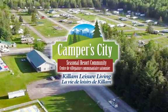 An aerial view of a campground named "Camper's City" with a logo in the center.