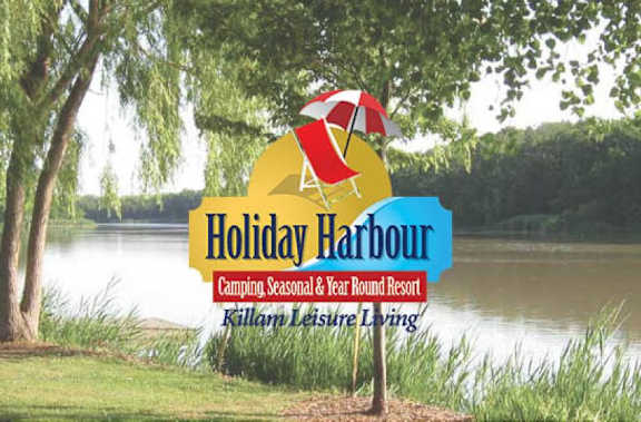 A graphic with Holiday Harbour on it. Water and river behind the graphic