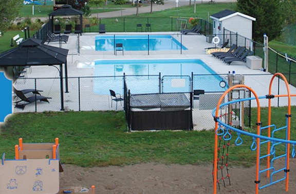 A playground with a slide and a pool.