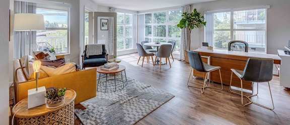 a living room and dining room with a table and chairs