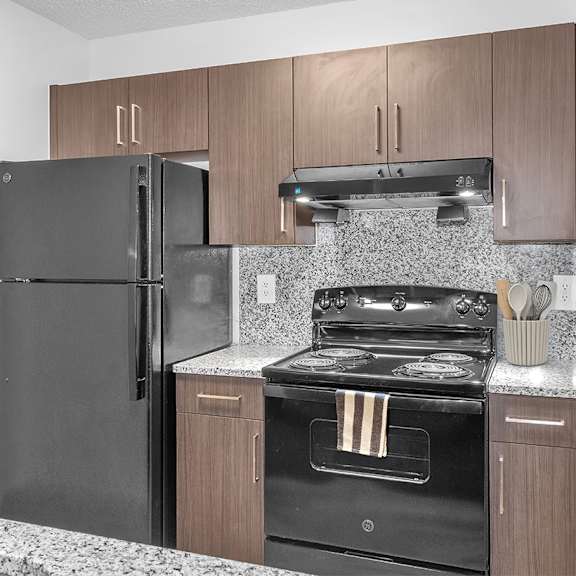 Kitchen with stove at Cedar Grove Apartments in Miami FL