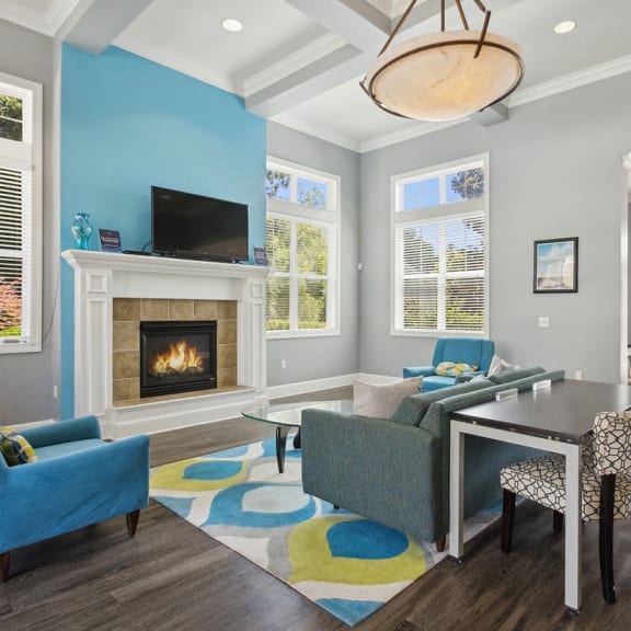 a room with a fireplace and a table and chairs