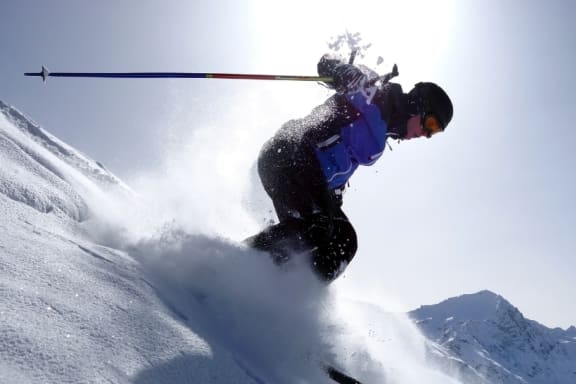 A skier is seen in action, carving through the snow on a mountain slope. at Yellowstone Landing, Belgrade, 59714