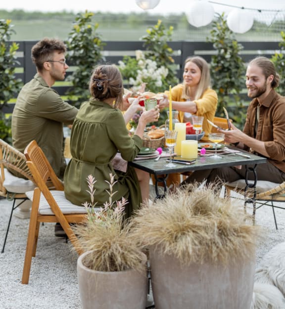 Four people toasting with drinks at a table. at Yellowstone Landing, Belgrade, MT