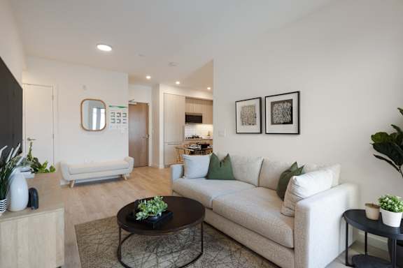 A living room with a white couch and a coffee table.