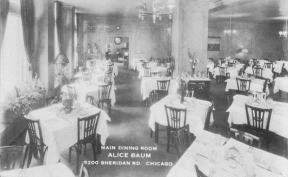 a black and white photo of a dining room with tables