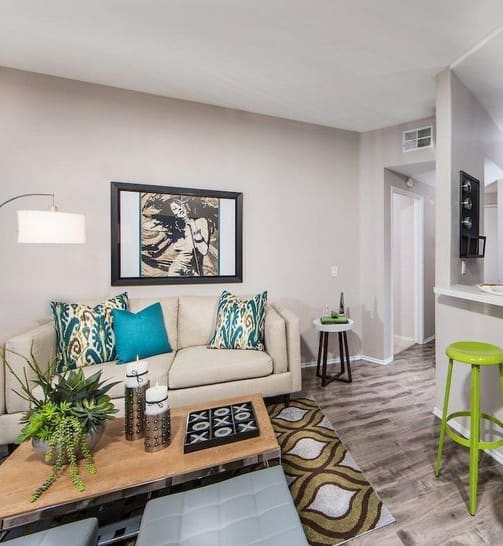 a living room with a couch and two stools