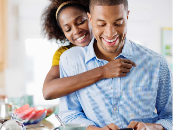 Couple smiling together looking at a phone at Cole Spring Plaza Apartments, Silver Spring, 20910