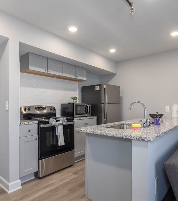 Bright and Modern Kitchen with Cabinets at University Digs Apartments, Pittsburg