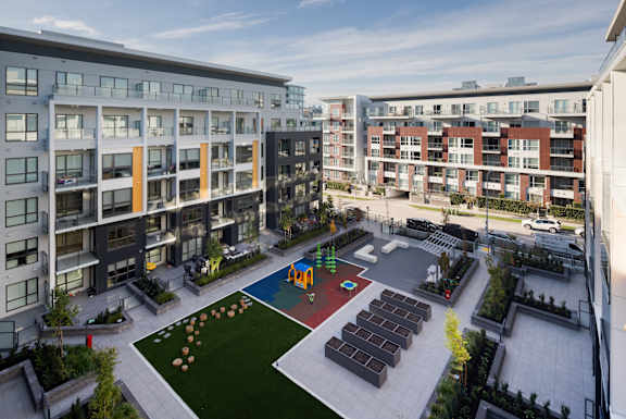 A view of a courtyard with a playground and apartment buildings.