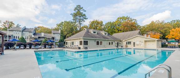 A large swimming pool with a building in the background.